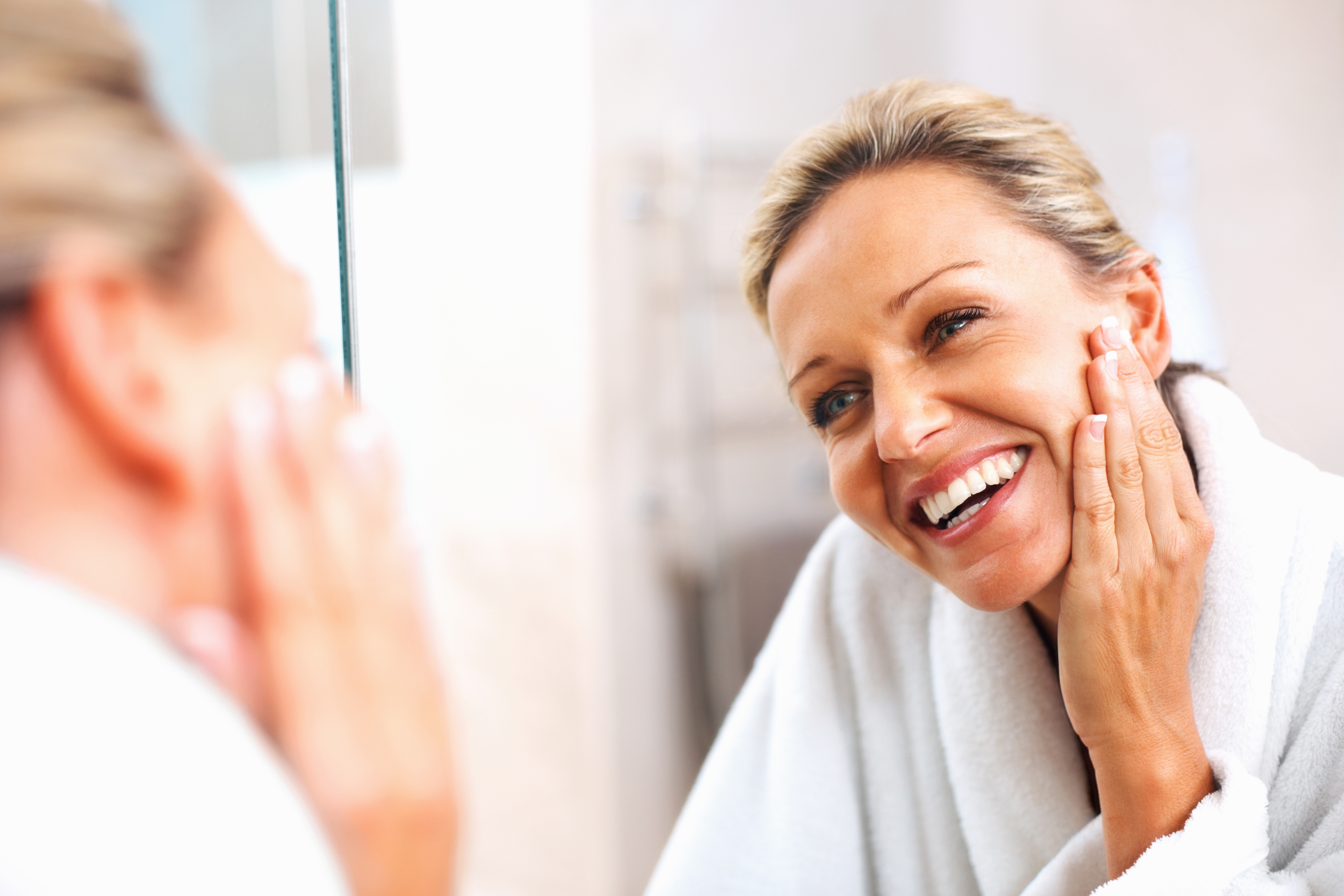 LookingInMirrorCleaningFace_Women_SkinCare_StockLifestyle_StockImages_U.S_shutterstock_64608160.jpg