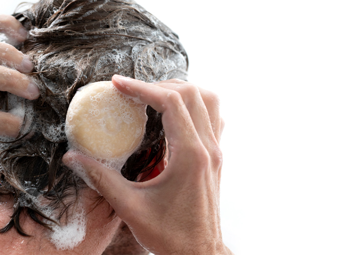 Man using doTERRA hair Shampoo Bar